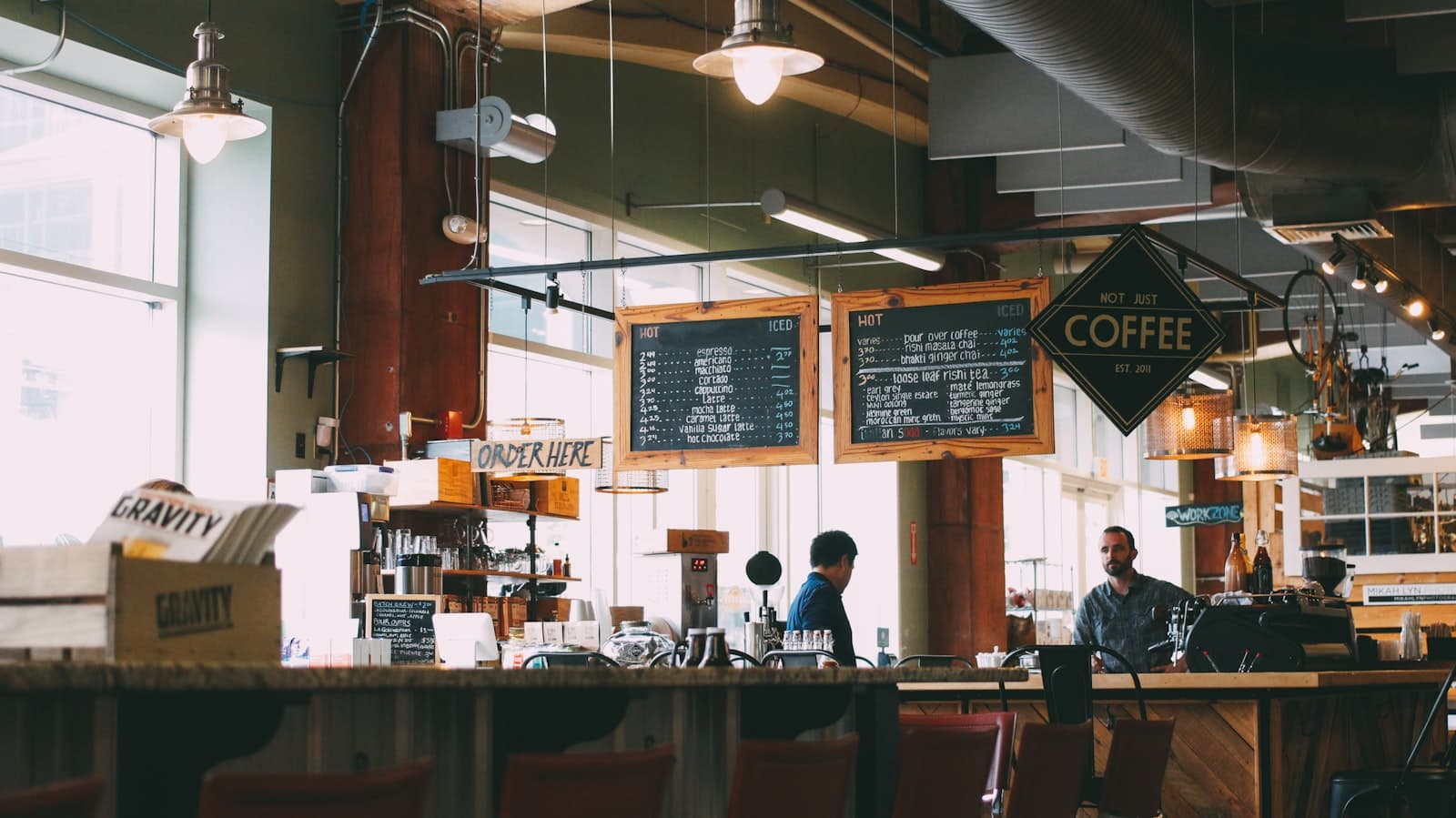 Bright independent coffee shop interior with chalkboard menus and an order counter